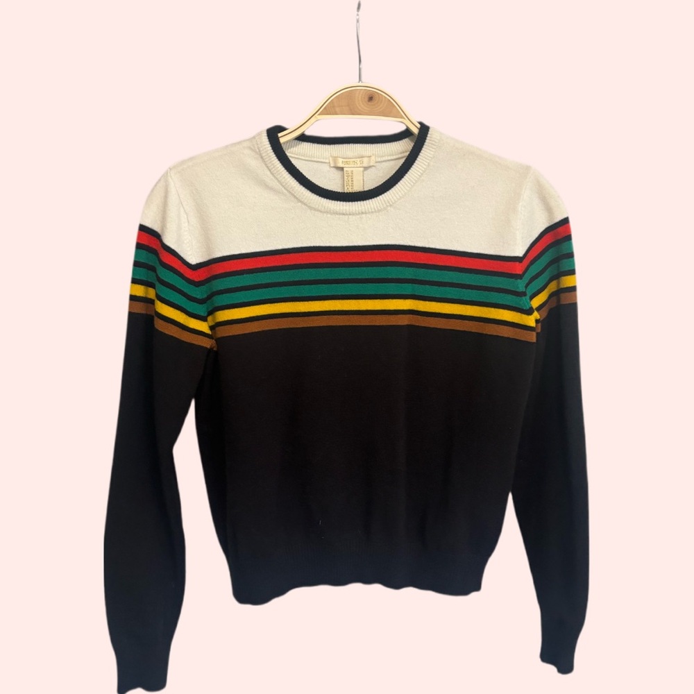 Cute sweater, not thick or thin.  Feels nice on, soft type material.